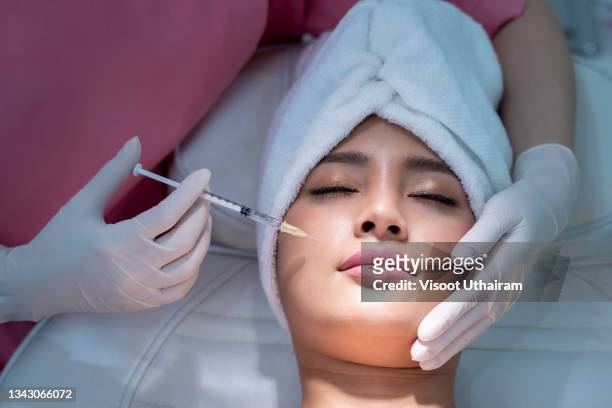 beauty treatment with hyaluronic collagen injection,young woman has a botox injections. - face mask protective workwear imagens e fotografias de stock