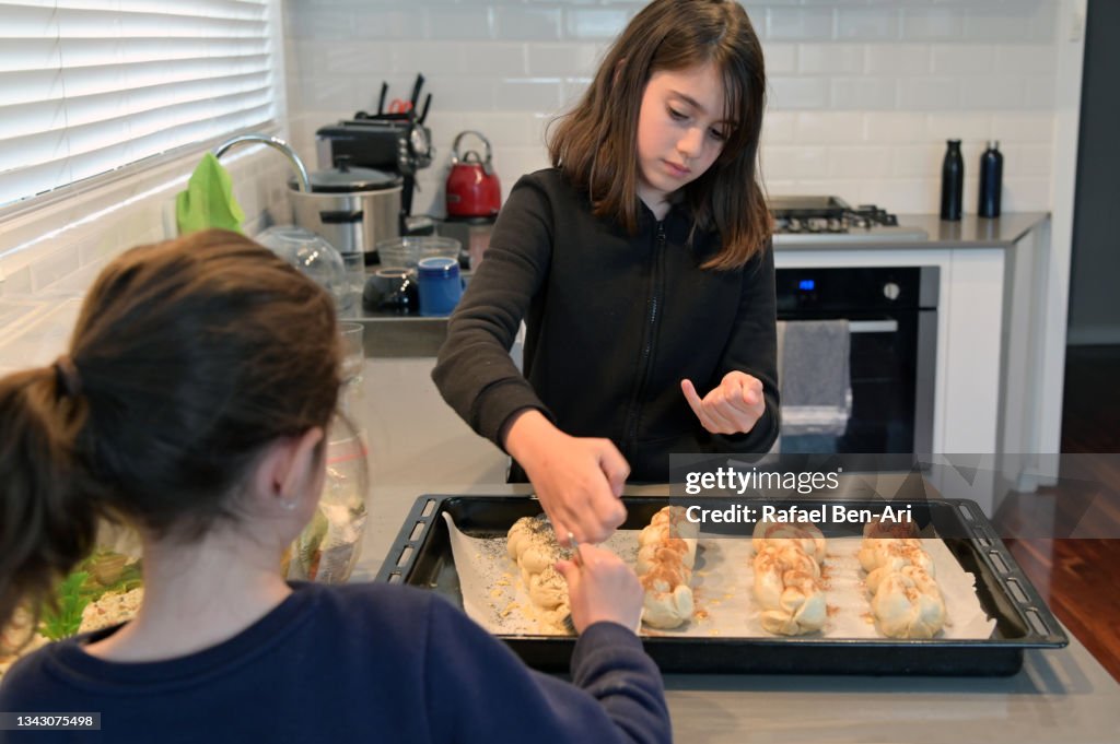 Young Jewish girls baking challah bread for Sabbath Jewish holiday