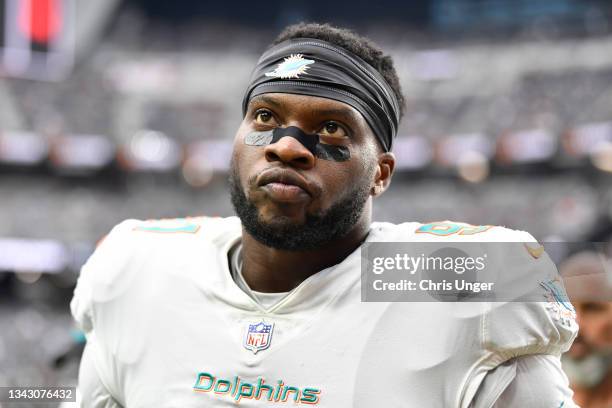 Defensive end Emmanuel Ogbah of the Miami Dolphins walks off the field after warmups before a game against the Las Vegas Raiders at Allegiant Stadium...