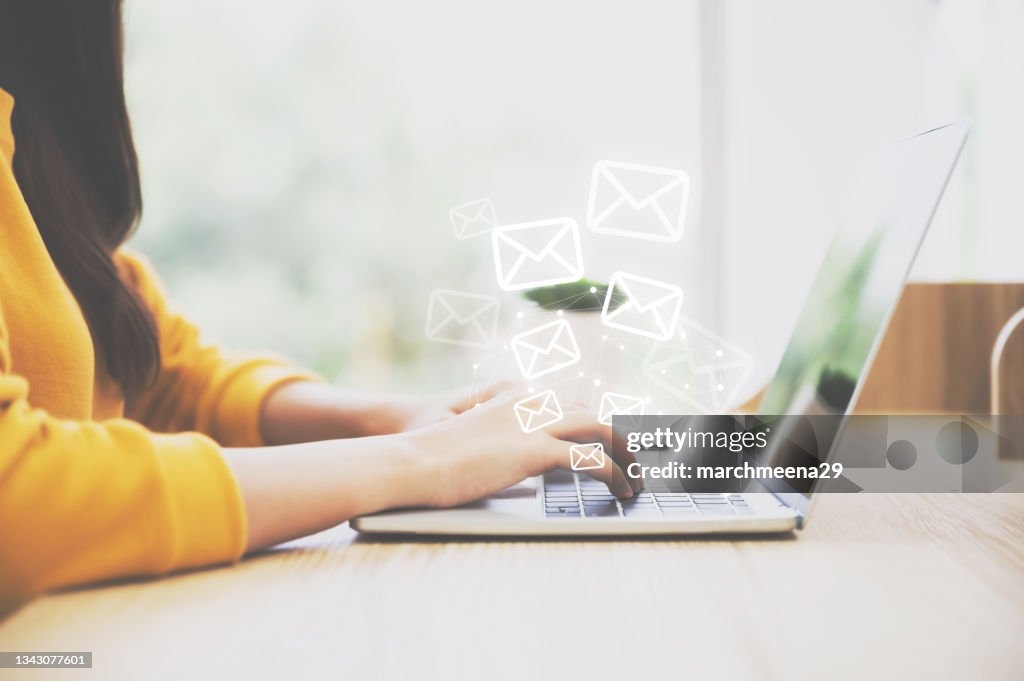 Woman hand using computer laptop pc with email icon. Concept of email and contact us