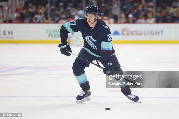 Dennis Cholowski of the Seattle Kraken skates with the puck against the Vancouver Canucks in the first period during a preseason game at Spokane...