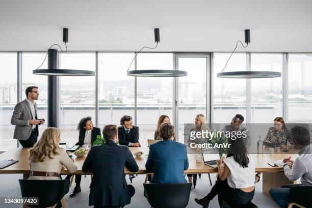 business meeting in a bright office - business meeting stock pictures, royalty-free photos & images