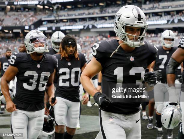 Running back Trey Ragas, cornerback Damon Arnette and wide receiver Hunter Renfrow of the Las Vegas Raiders walk off the field after warmups before a...