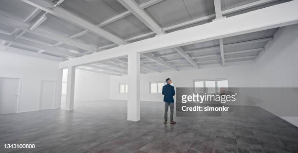 businessman looking at unfurnished office - unfurnished stock pictures, royalty-free photos & images