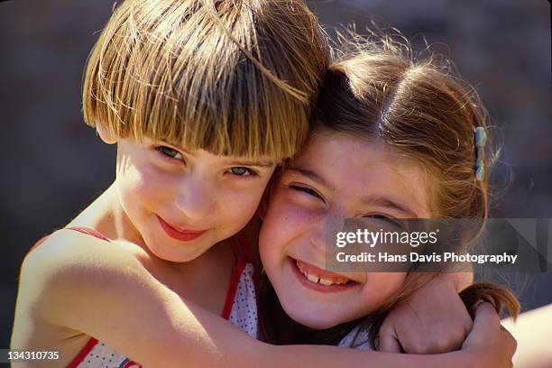 two young girls smiling at camera - smiling child stock pictures, royalty-free photos & images