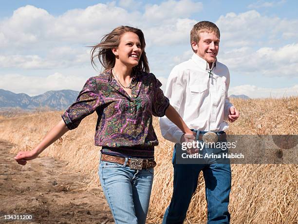 couple holding hand and running - broomfield colorado stock pictures, royalty-free photos & images