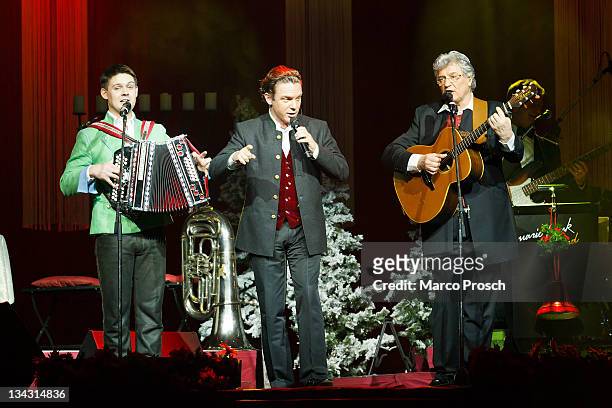 Florian Fesl, Stefan Mross and Michael Hartl perform on stage during the 'Alpenlaendische Weihnacht' Show at the Goebel's Hotel Arena on November 30,...