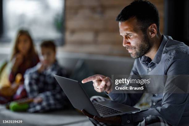 angry man having video call while working from home during coronavirus pandemic. - online threats stock pictures, royalty-free photos & images