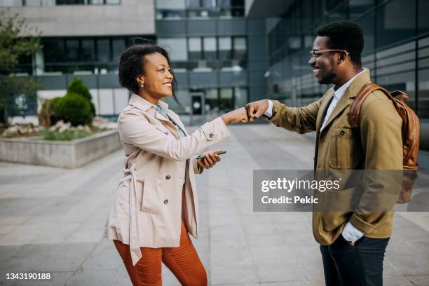 let's work! - fist bump stock pictures, royalty-free photos & images
