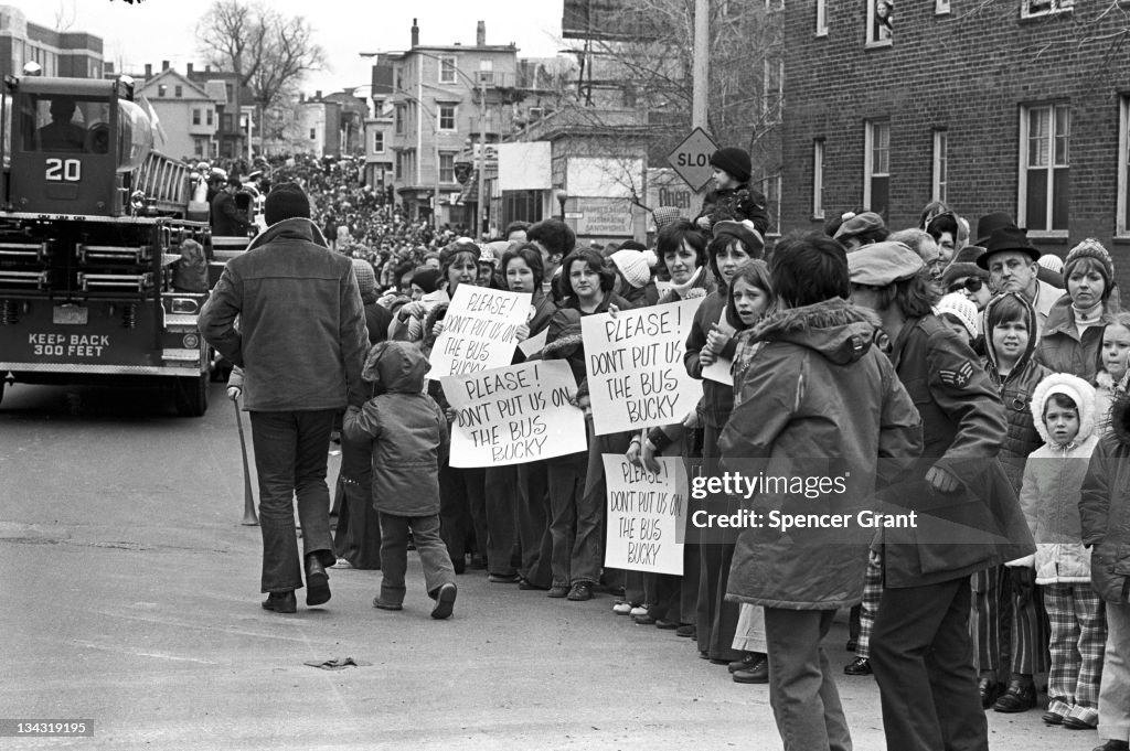 Busign Anti-busing protestors line a street to demonstrate against forced ...