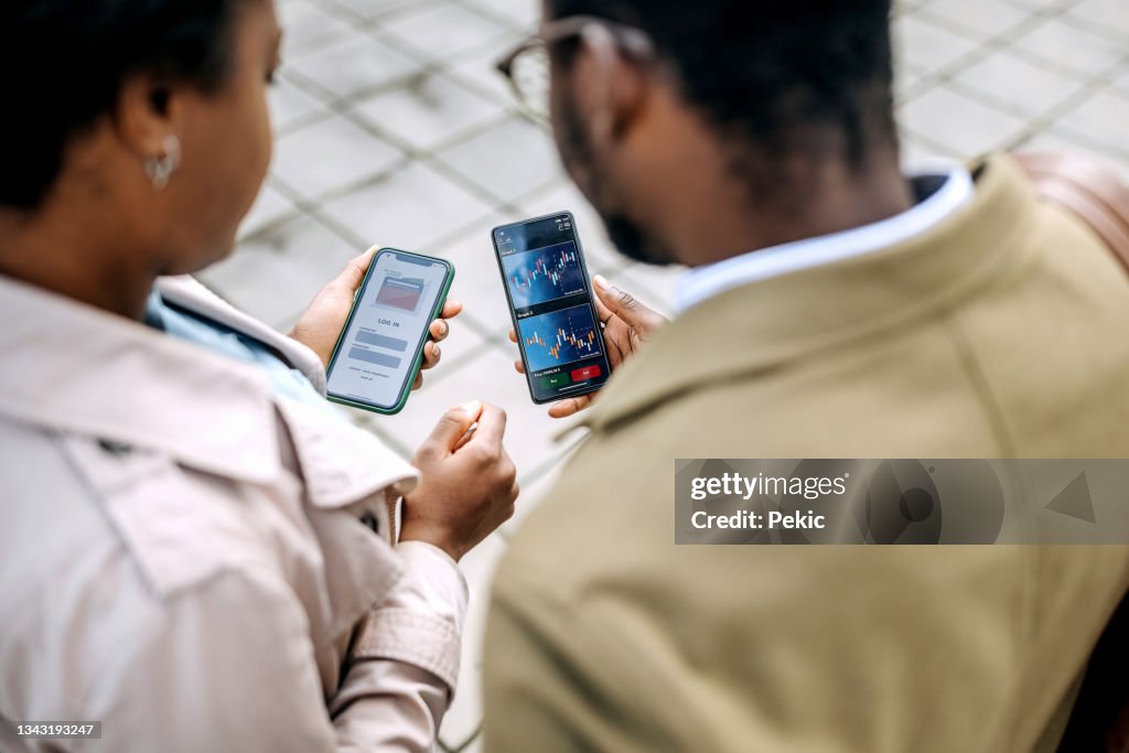 Young colleagues checking their crypto investment app