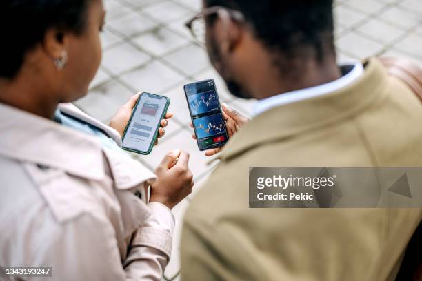 young colleagues checking their crypto investment app - fintech stock pictures, royalty-free photos & images