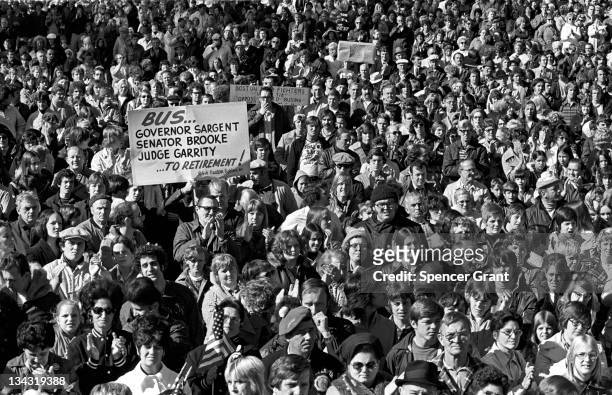 Large crowd gathers in South Boston's Columbus Park to protest federal court-ordered busing of black students to all-white neighborhood schools, 1975.