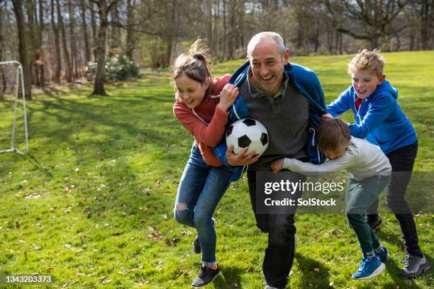 one big happy family - person with soccer ball imagens e fotografias de stock