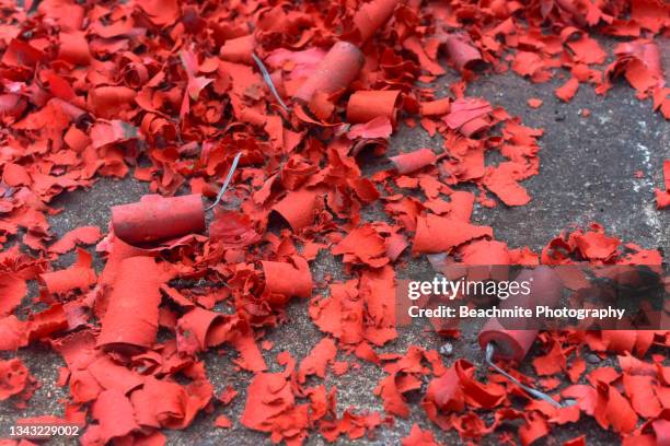 high angle view of spent/exploded firecrackers on the road during chinese new year. for backgrounds and copy space - firework explosive material stock pictures, royalty-free photos & images