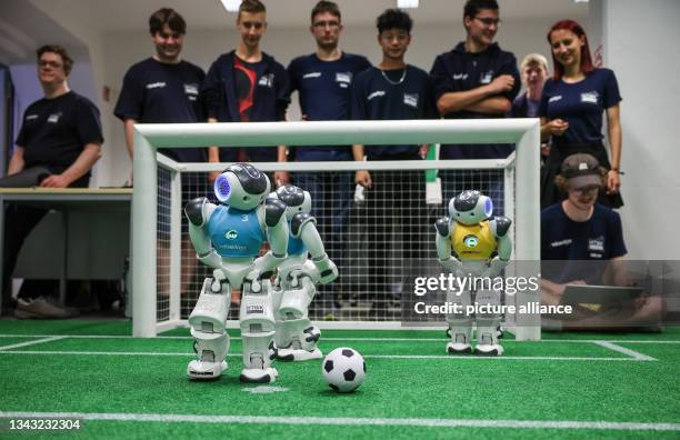 June 2023, Saxony, Leipzig: Nao robots play soccer during a training game in a laboratory at the Leipzig University of Applied Sciences . Having...