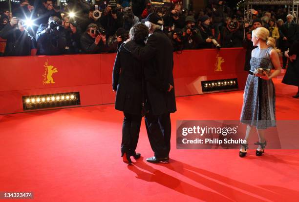 Actor Michael Gwisdek and partner Gabriela Lehmann pose on the red carpet next to actress Hannah Herzsprung prior to the Award Ceremony during day...