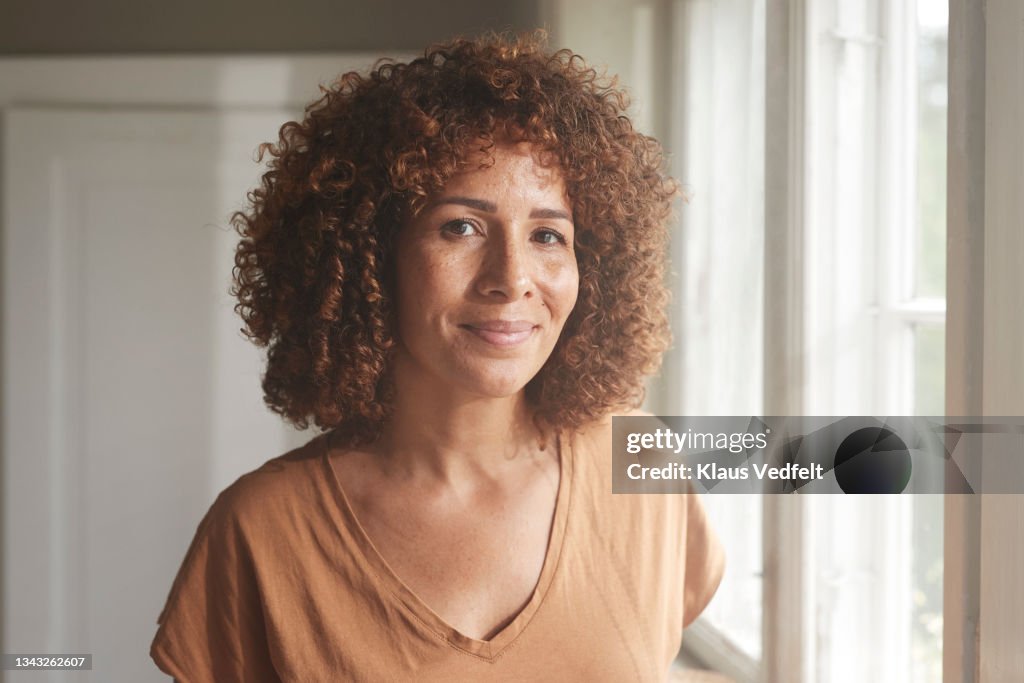 Smiling woman with curly brown hair