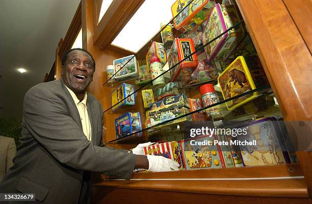 Meadowlark Lemon of the Harlem Globetrotters places the Harlem Globetrotters lunchbox into the "Taking America to Lunch" display, which opens today...