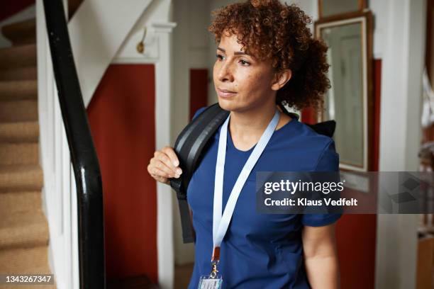 female healthcare worker with backpack - nurse leaving stock pictures, royalty-free photos & images