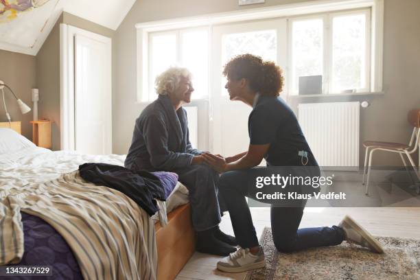 senior woman talking with female nurse - senior getting dressed stock pictures, royalty-free photos & images