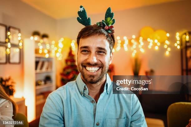 smiling bearded man with christmas disguise - christmas hat stock pictures, royalty-free photos & images