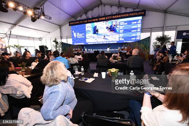 Spectators watch the TCS New York City Marathon in the Blue Line Lounge on November 3, 2019 in New York City.
