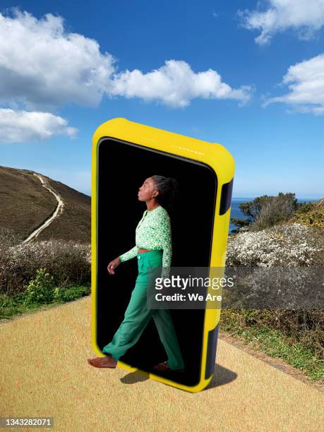 woman walking out of mobile phone into nature - media day bildbanksfoton och bilder