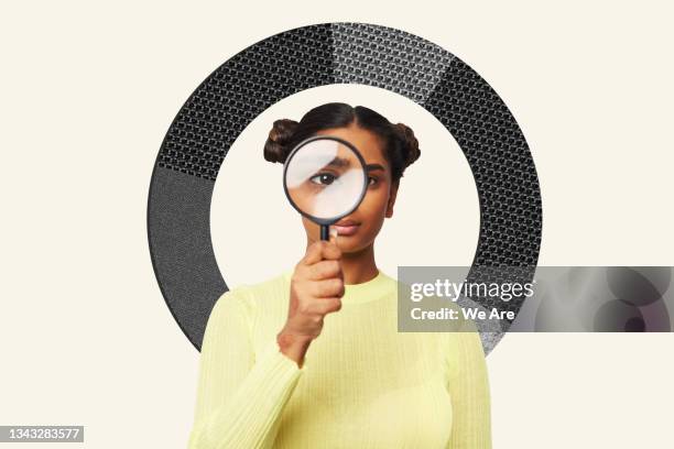 woman looking through magnifying glass - things that are round stock-fotos und bilder