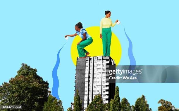 two women watering trees in city - montage stock-fotos und bilder