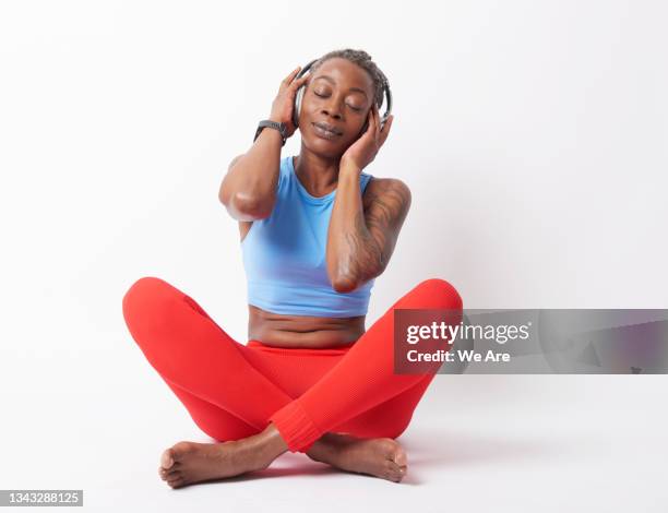 mature woman wearing headphones, day dreaming lost in sound - portrait zen stock pictures, royalty-free photos & images