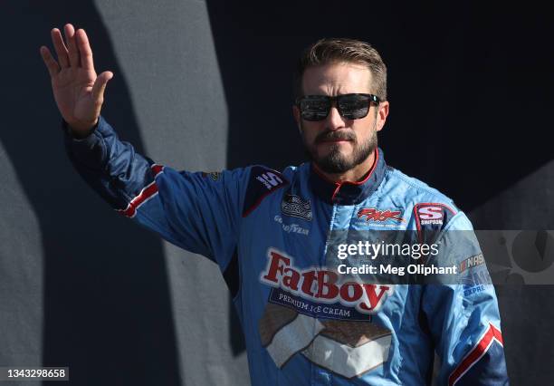 Yeley, driver of the Fat Boy Ice Cream Toyota, waves to fans during pre-race ceremonies prior to the NASCAR Cup Series South Point 400 at Las Vegas...