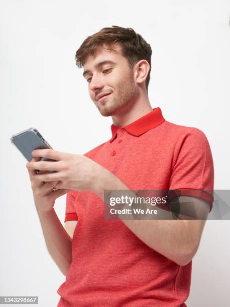 young man using smartphone - smart phone on white stock pictures, royalty-free photos & images