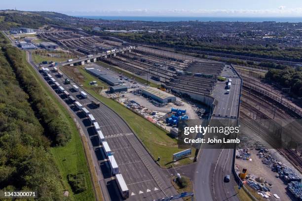 aerial view of lorries queuing to board the eurotunnel train at the folkestone terminal. - channel tunnel stock pictures, royalty-free photos & images