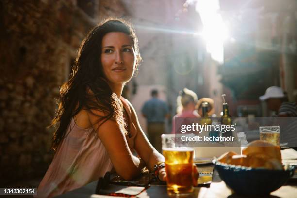portrait of a young woman at the seaside restaurant - istrië stockfoto's en -beelden