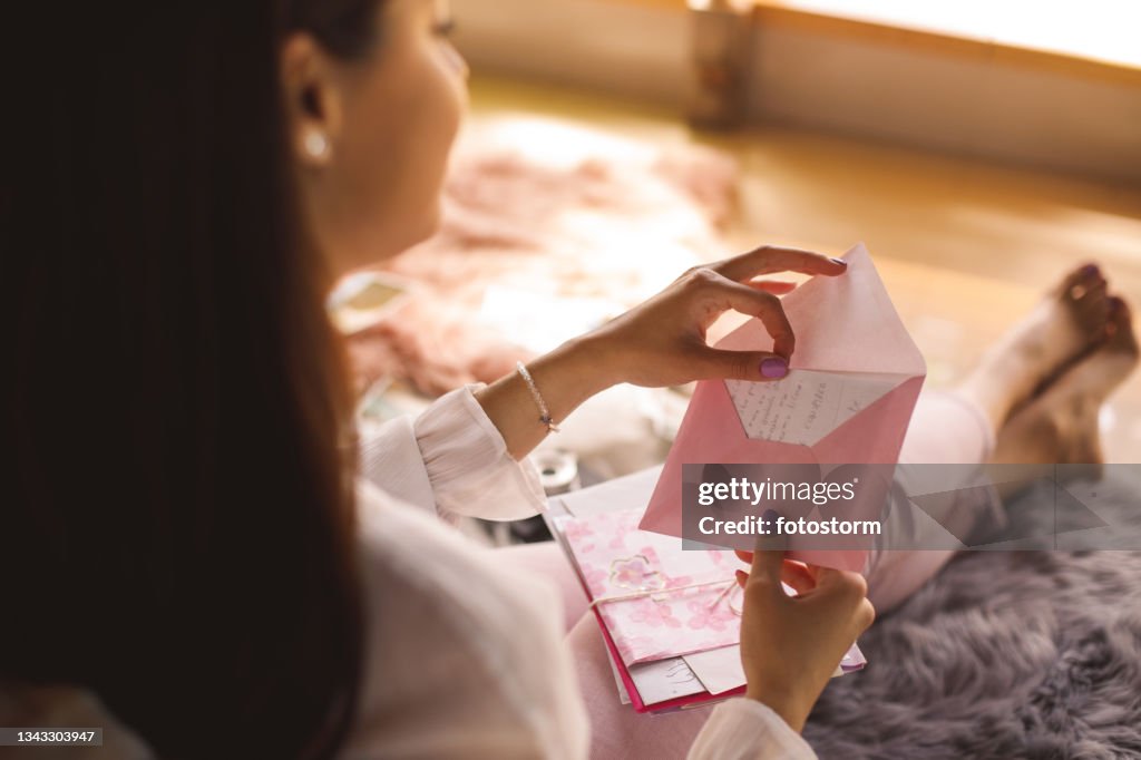 Young woman opening a love letter