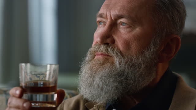 Portrait thoughtful senior man drinking whiskey. Wealth retirement life concept