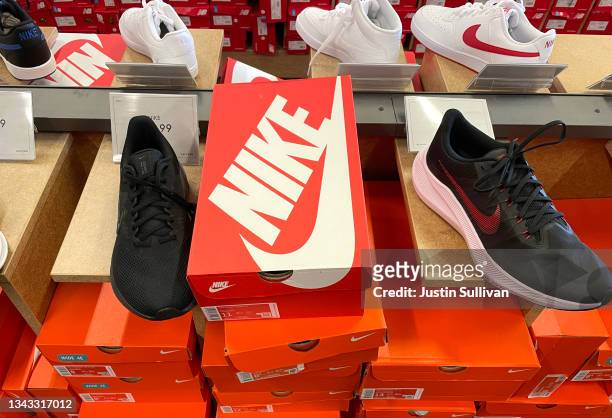 Nike shoes are displayed at a shoe store on September 27, 2021 in Novato, California. Nike has had to downgrade its fiscal 2022 revenue outlook as...