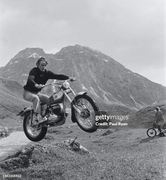 View of French alpine skier and Olympian Jean-Claude Killy as he jumps his motocross motorcycle on a hill near his home, Val d'Isere, France, 1969.