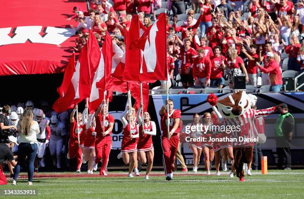 Cheerleaders the Bucky Badger lead the Wisconsin Badgers on to the field against the Notre Dame Fighting Irish at Soldier Field on September 25, 2021...