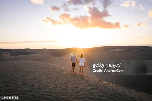 two people watching the sunset in maspalomas. grand canary, canary islands, spain - maspalomas imagens e fotografias de stock