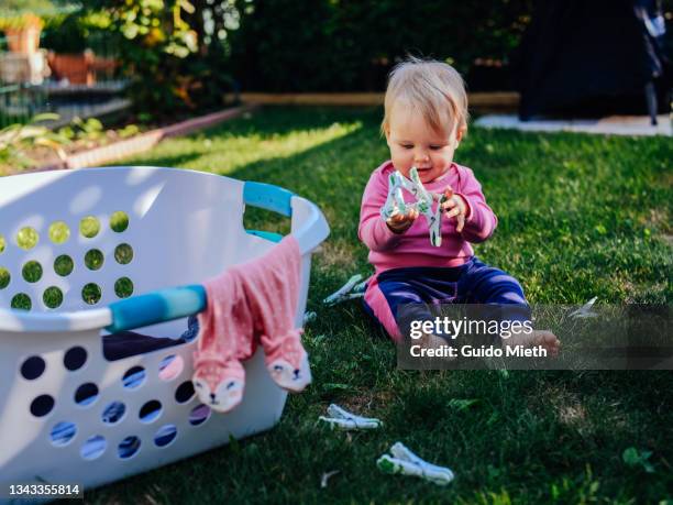 cute toddler playing with clothespin outdoor. - clothespin stock pictures, royalty-free photos & images
