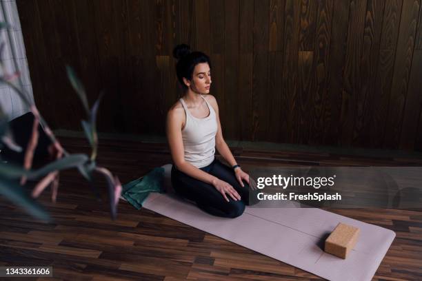 beautiful young woman practicing yoga - yoga block stock pictures, royalty-free photos & images