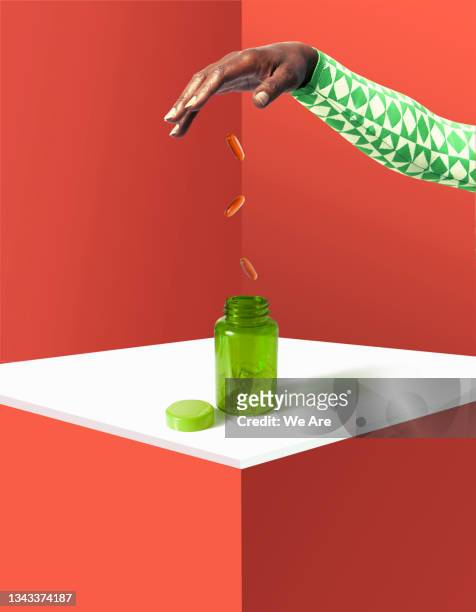 hand pouring coins into tablet bottle - pill bottles stock pictures, royalty-free photos & images