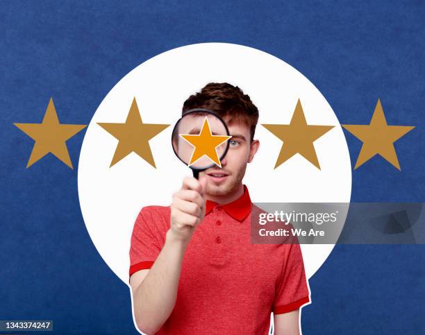 man looking through magnifying glass at 5 stars - customer experience stock pictures, royalty-free photos & images