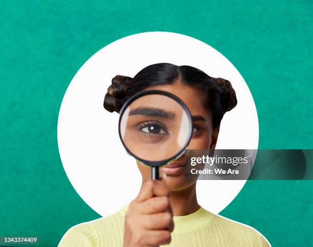 woman looking through magnifying glass - discovery stock pictures, royalty-free photos & images