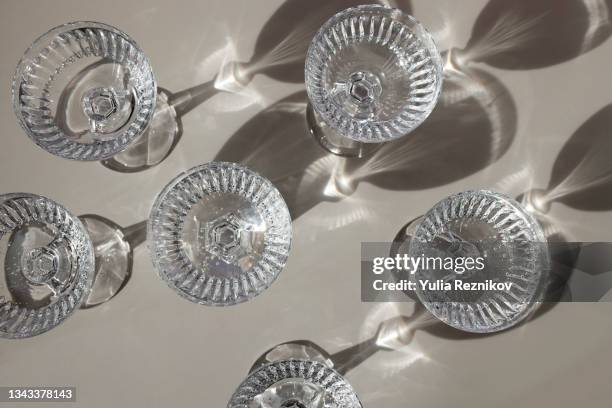 top view of repeated champagne glasses on the beige background - champagne flute high angle stock pictures, royalty-free photos & images