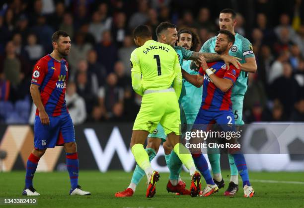 Shane Duffy of Brighton & Hove Albion seperates Robert Sanchez and Joel Ward of Crystal Palace during the Premier League match between Crystal Palace...