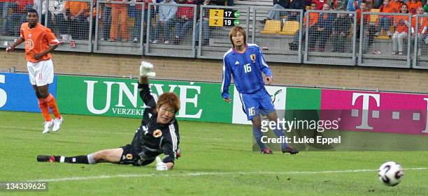 Tomokazu Nagira and Shusaku Nishikawa look on helplessly as the Japenese defense is breached at the Parkstad Limburg Stadium in Kerkrade, Netherlands.