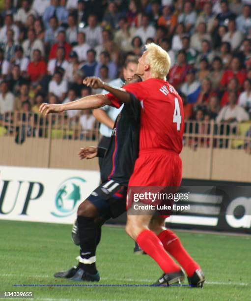 Liverpool's Sami Hyypia and Vagner Love vie for aerial possession of the ball on the edge of the Liverpool goal area in the UEFA Super Cup at the...